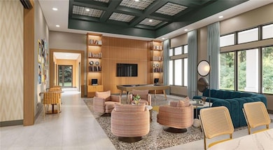 Lobby with a towering ceiling, coffered ceiling, recessed lighting, and beamed ceiling