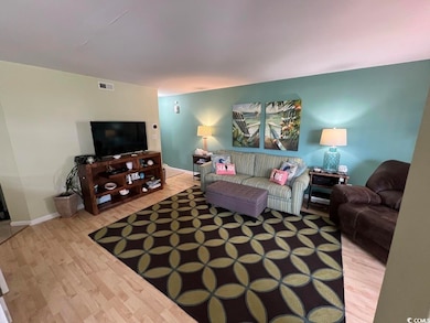 Living area featuring wood finished floors and baseboards