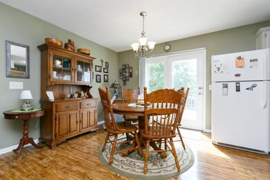 Dining area with door to deck. (Refrigerator was temporarily moved to this location for easier wheelchair access to kitchen)