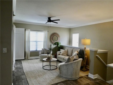 The spacious Living Room with neutral tile floor, looking from the dining area.