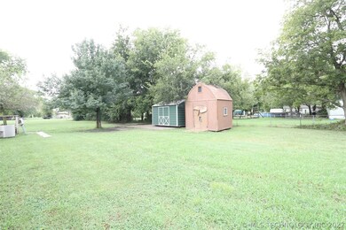 Mature trees on large flat acre lot and 2 storage