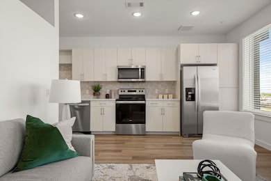 Kitchen with light wood-style floors, light count