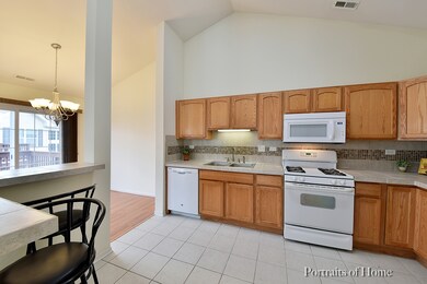 Kitchen also boasts vaulted ceiling
