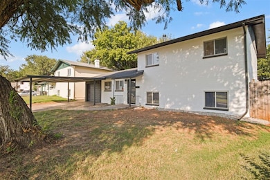 Rear view of house featuring a yard