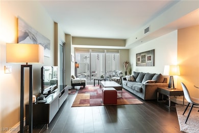Living room with dark wood-type flooring
