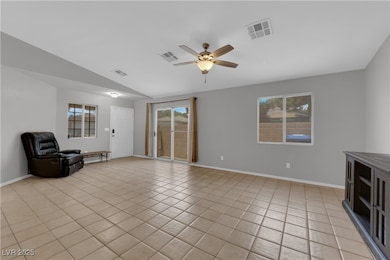 Unfurnished living room featuring ceiling fan, ple