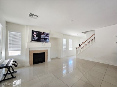 Unfurnished living room featuring light tile patte