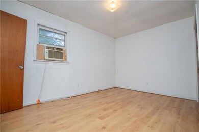Spare room featuring light wood-type flooring and cooling unit