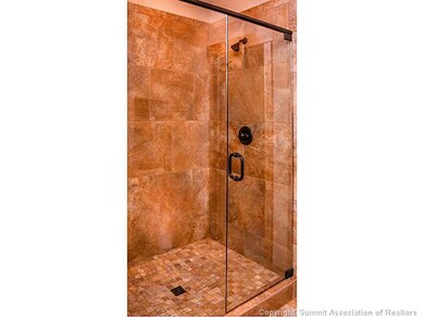 Bathroom. Fully tiled shower stall with glass show