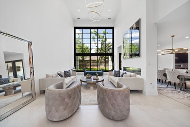 Formal living room with wall of windows overlookin