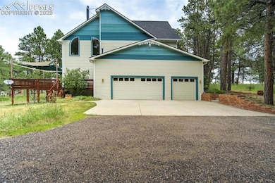 View of exterior with driveway, a wooden deck, and a garage