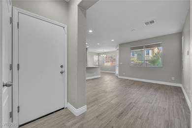 Entrance foyer featuring a chandelier, light wood