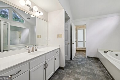 The Main-Level Primary Suite features Double Vanit