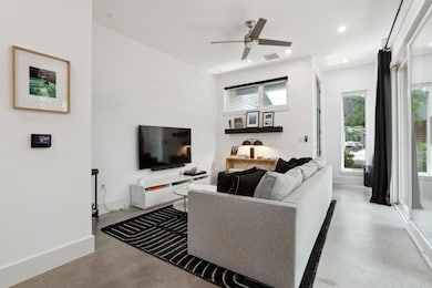 Living room featuring concrete flooring, ceiling 
