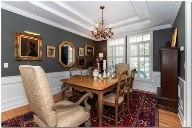 The open-concept formal dining room is accented wi