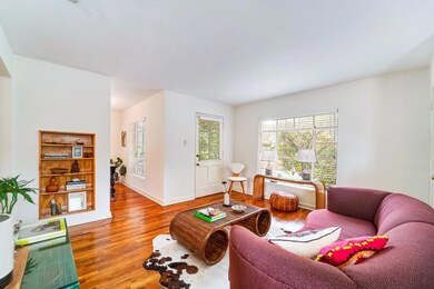 Living room with wood finished floors and baseboa