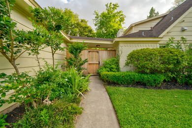 Landscaped sidewalk to breezeway.