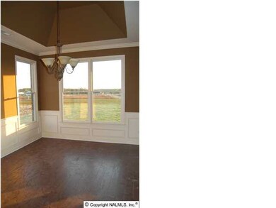 Dining room over looks the back yard. Plenty of natural light. Soaring ceiling, chair rail, shadow boxes and wood floors.