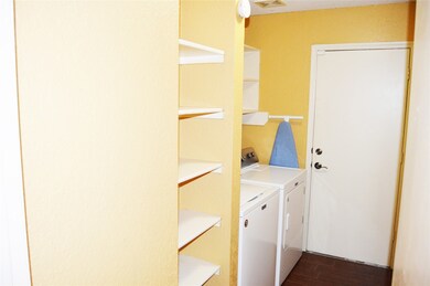 Laundry Room with Washer, Dryer, and Ironing board included.