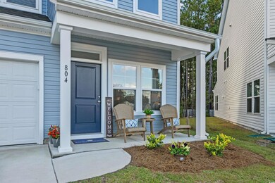 Property entrance with covered porch and a garage