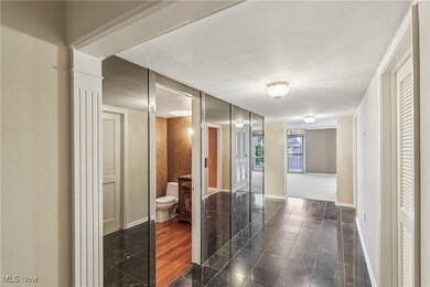 Foyer with marble flooring and a powder room.