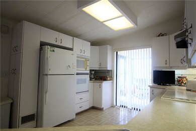 large Kitchen with lots of cabinets & sliders to F
