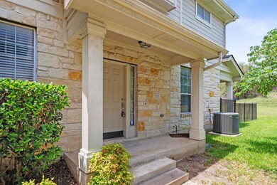 Entrance to property featuring stone siding, cent