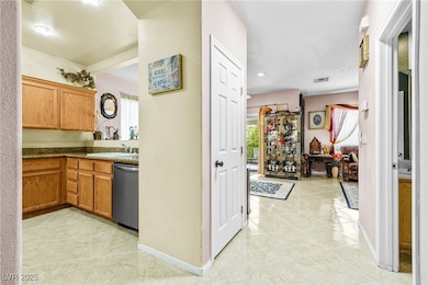 Hallway featuring light tile patterned floors, bas