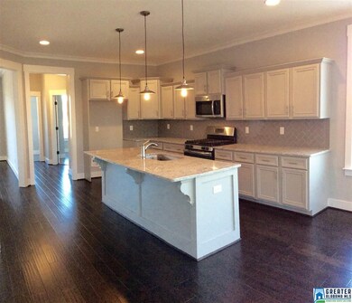The spacious gourmet kitchen features a large work