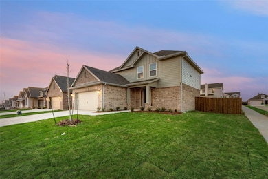View of front of property with concrete driveway, an attached garage, brick siding, board and batten siding, and a residential view