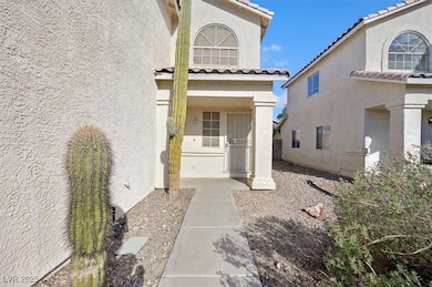 Doorway to property featuring stucco siding and a tiled roof