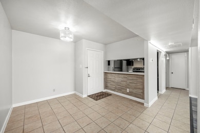 View towards the kitchen area from dining room. Enjoy additional seating around kitchen bar area.