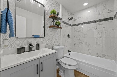 Full bathroom featuring tiled shower / bath combo,