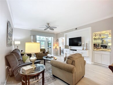 Living room featuring crown molding, ceiling fan,