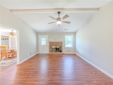 Unfurnished living room with ceiling fan, light wo