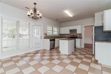 Kitchen with a center island, a notable chandelier