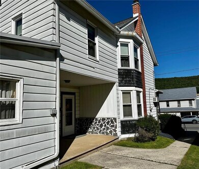 Covered concrete side porch offers a relaxing priv