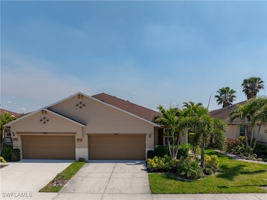 View of front of home with stucco siding, an attac