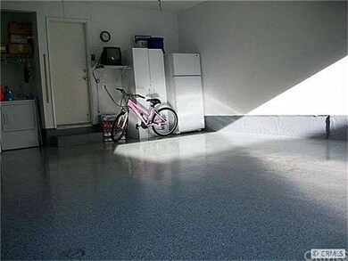 GARAGE WITH CUSTOM CABINETS AND , EPOXY FLOORS AND