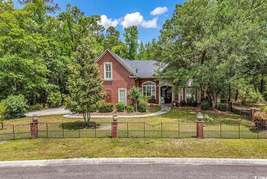 View of front of house with brick siding and a fenced front yard