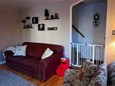 Living Room. Arched entry to 2nd floor staircase. 