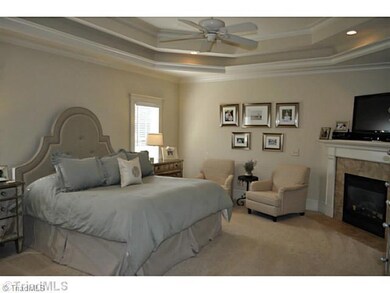 Master Bedroom. This luxurious master suite offers a tray ceiling, gas log fireplace and a spa bath, as well as a big walk-in closet.