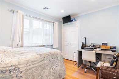Bedroom with recessed lighting, visible vents, a closet, crown molding, and light wood-style flooring