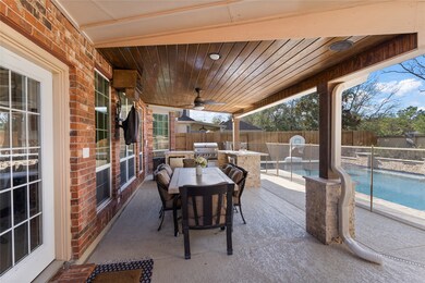 Beautiful covered patio with wood tongue-in-groove ceiling, sonic ice machine, wired tv, and outdoor fan. Outdoor kitchen is only one year old.