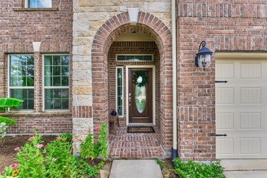 Brick and stone exterior frame the charming covere