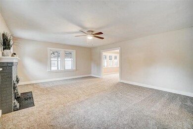 Living area view from the front door.  The room in the distance is the dining room.  Yes, those are ALL NEW windows throughout the house.  In fact, everything is new in this house, practically.  The faux fireplace  really anchors this large room.  Co