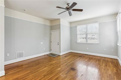 Empty room featuring hardwood / wood-style flooring and a ceiling fan