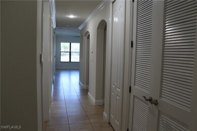 Hall featuring light tile patterned floors, crown