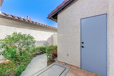 Property entrance featuring stucco siding