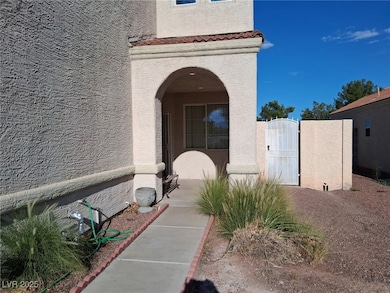 Entrance to property featuring a gate and stucco siding